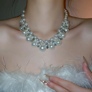 Detail of layered pearl necklace with sparkling rhinestones on an elegant model