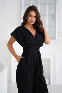 Detail of elegant black V-neck jumpsuit with waist tie and wide leg silhouette