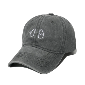 Washed black cotton baseball cap with cute white penguin embroidery on front panel