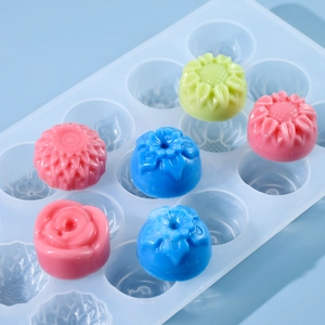 Close-up of 15-cavity blue silicone flower mold with rose and sunflower shaped crafts