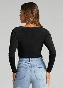 Rear view of a black long-sleeved knitted Y2K style yoga top on a professional model