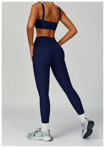 Back view of navy ribbed yoga set featuring cross-back sports bra and high-waist leggings