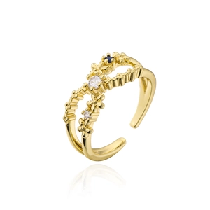 Gold plated open ring with flower design and white blue zircon stones on white background