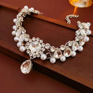 Elegant silver flower necklace with sparkling crystals and a large teardrop pearl pendant