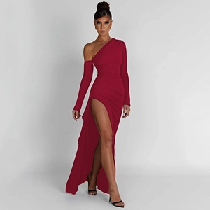 Detail of dark red one-shoulder dress with high slit and long sleeves on white background