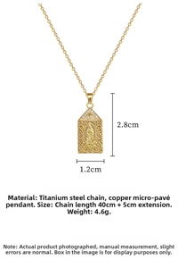 Macro detail of gold religious portrait pendant with white cubic zirconia and titanium chain