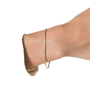 Minimalist gold box chain bracelet shown on a wrist with a detailed metal finish