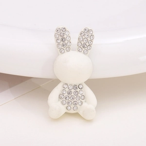 Detailed close-up of a white rabbit-shaped resin charm with sparkling rhinestone inlay