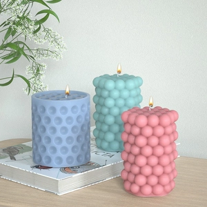 Detailed view of bubble and dot cylinder silicone molds with pastel resin craft samples