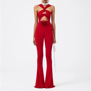 Detailed view of red halter neck jumpsuit with cutout design and 3D floral decoration