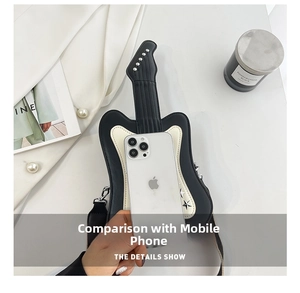 Top view of guitar-shaped shoulder bag with metallic studs next to a smartphone size guide