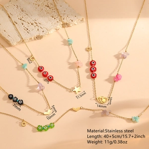Golden stainless steel necklaces with heart, star, and evil eye charms on stones