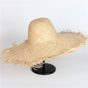 Women's wide brim raffia straw sun hat with frayed edges for romantic beach vacations