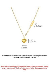 Detailed view of the titanium steel heart pendant necklace with gold letter H and chain links