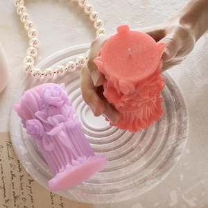 Detailed relief rose bouquet candle in pastel purple and pink with floral column design