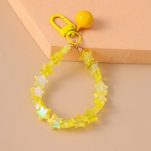 Detailed view of yellow star-shaped beaded keychain with bell and metal clasp