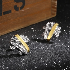 Close-up of hip hop style two-tone crossover earrings with shimmering zircon inlays