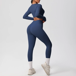 Detail of high-waist navy yoga leggings with functional side pocket and matte fabric texture