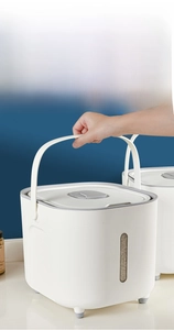 Detail view of portable rice storage bin with handle and clear window for food level