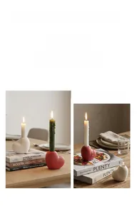 Detailed view of red and white heart-shaped ceramic candle holders on a wooden table