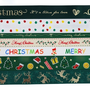 Detail of Christmas ribbons with Merry Christmas prints and holiday motifs on fabric