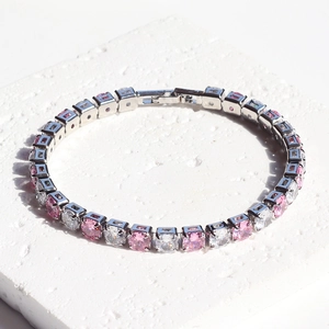 Minimalist tennis bracelet with pink and white square-cut zircons on a stone base