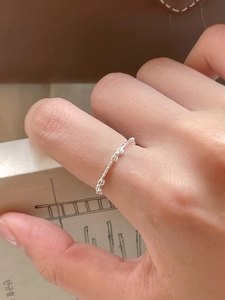 Detail view of 925 sterling silver bow knot ring on finger with minimalist design