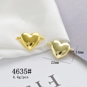 Macro shot of 22x14mm golden heart charms with side loops for DIY jewelry making