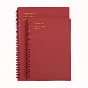Deep red Morandi A5 spiral notebooks in two sizes with gold lettering on white background