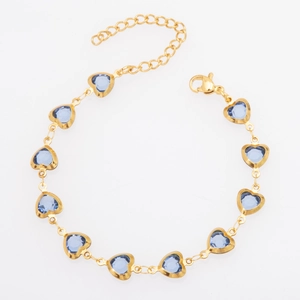 Detail of gold heart bracelet with blue glass stones, lobster clasp and extension chain