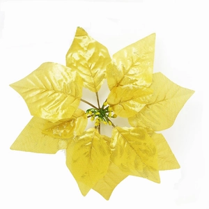 Macro view of artificial gold poinsettia with metallic petals and beaded center