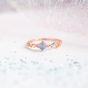 Detail of rose gold Saturn ring with blue moonstone and sparkling pave stones