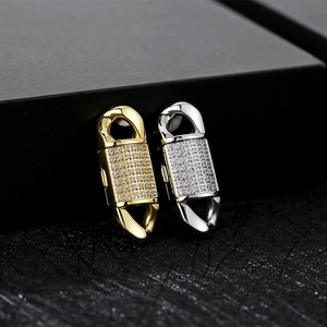 Macro detail of gold and silver cubic zirconia micro-pave fold-over clasps for Cuban chains