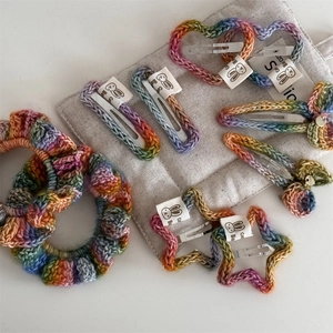 Rainbow crochet hair clip set featuring bow, heart, and star designs on white background