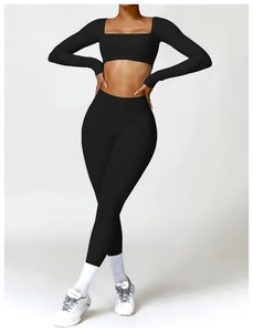 Close-up of black long sleeve crop top and high waist leggings yoga set on model