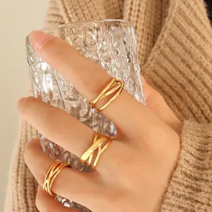 Three-piece gold plated stainless steel stacked rings in minimalist geometric cross design
