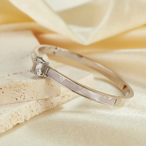 Detail of silver bangle with rectangular zircon and white enamel on stone layers