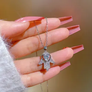 Hamsa Hand necklace in stainless steel featuring a heart-shaped zircon and pave setting