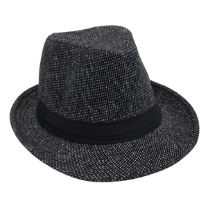 Detailed view of the woven black and white texture and black ribbon on the fedora hat