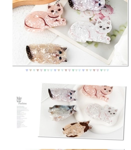 Detail of cute cat shaped hair claws in acetate finish with marble texture