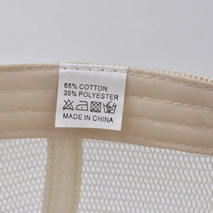 Detail shot of mesh baseball cap interior with cotton-polyester material and care label