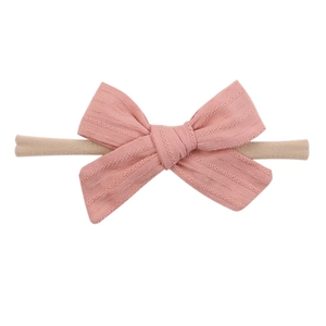 Pink polka dot fabric bow baby headband with beige elastic soft nylon band