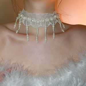 Detail of white mesh lace choker featuring dangling pearl tassels and elegant bead fringe