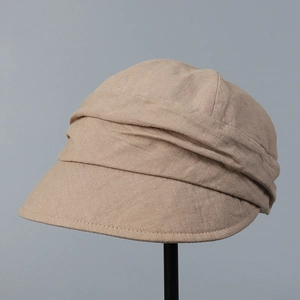 Detail of light khaki linen sun hat showing natural pleated texture and fabric weave