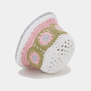 Close-up of handmade crochet hollow floral patterns on the knit bucket hat side