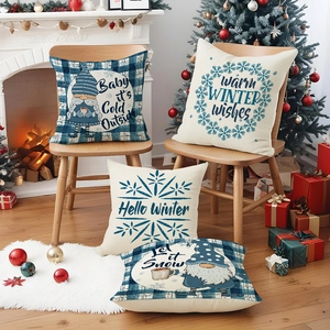 Set of four blue plaid Christmas pillow covers with gnomes on a festive indoor sofa
