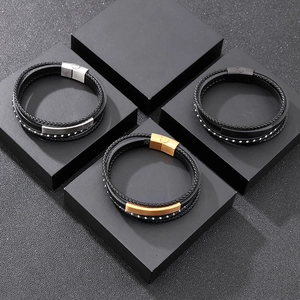 Close-up of woven leather bracelets with silver, gold, and black stainless steel magnetic clasps