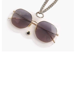 Detailed view of dark lens sunglasses in a transparent cat-ear soft pouch with chain