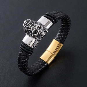 Men's braided leather bracelet featuring a silver skull and gold magnetic clasp