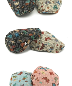 Detail view of colorful butterfly jacquard pattern on vintage flat caps in various colors